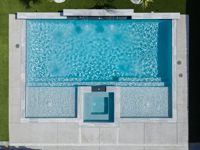 Drone view of a pool deck with stone coping
