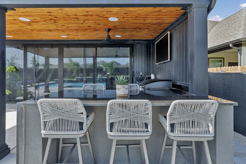 Bar stools at a covered patio counter