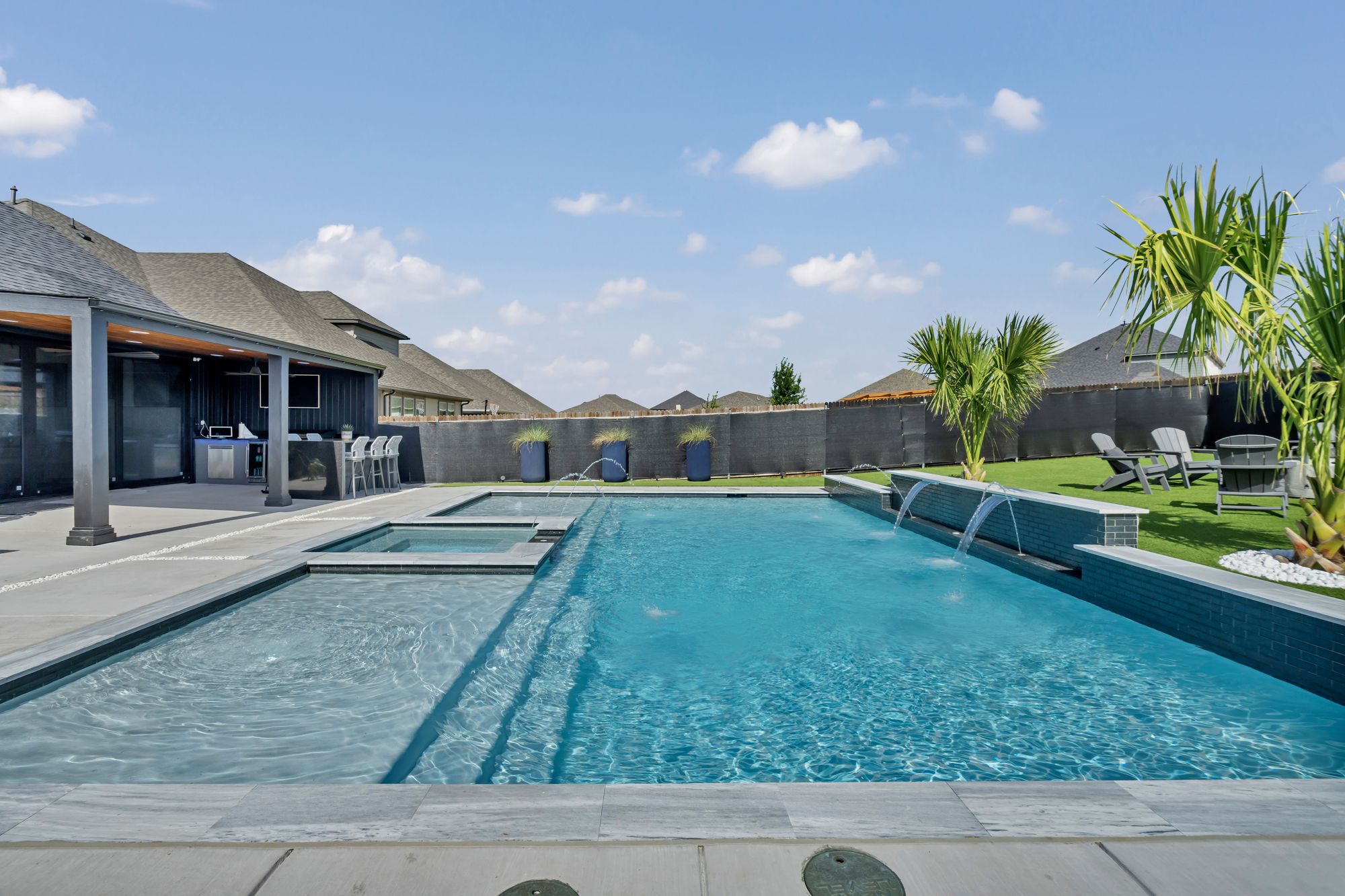 Tanning ledge with a bubbler, a spa and sheer descents