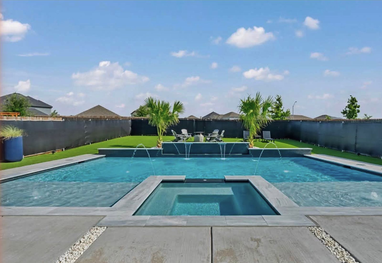 Rectangular gunite pool with a flush spa and bubblers