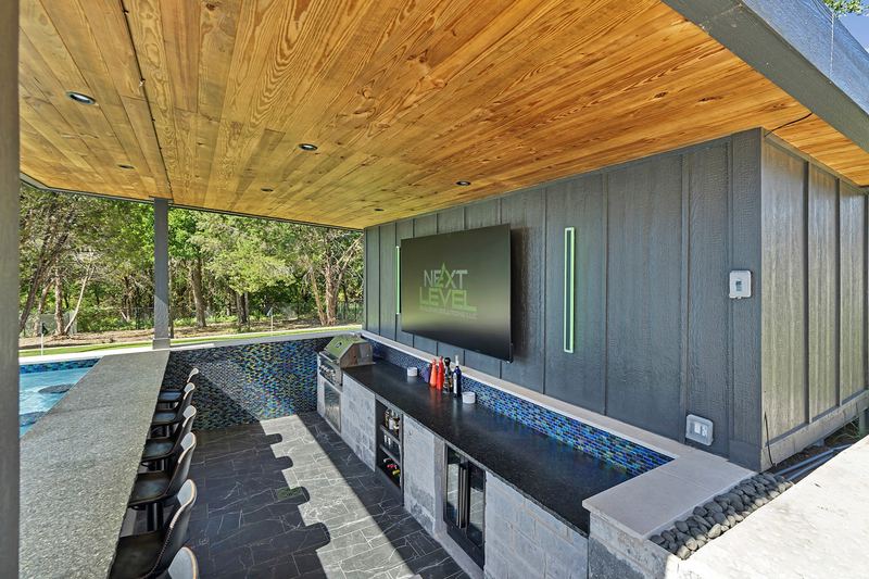 Swim up bar counter with mounted TV